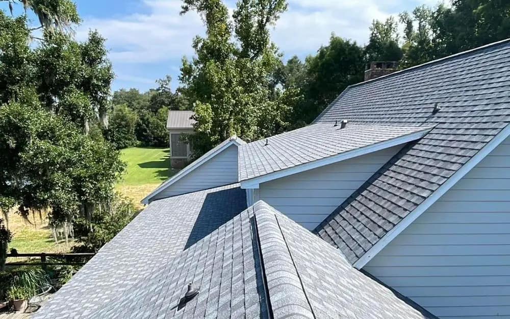 Aerial view of a newly replaced architectural shingle roof on a Gulf Coast home