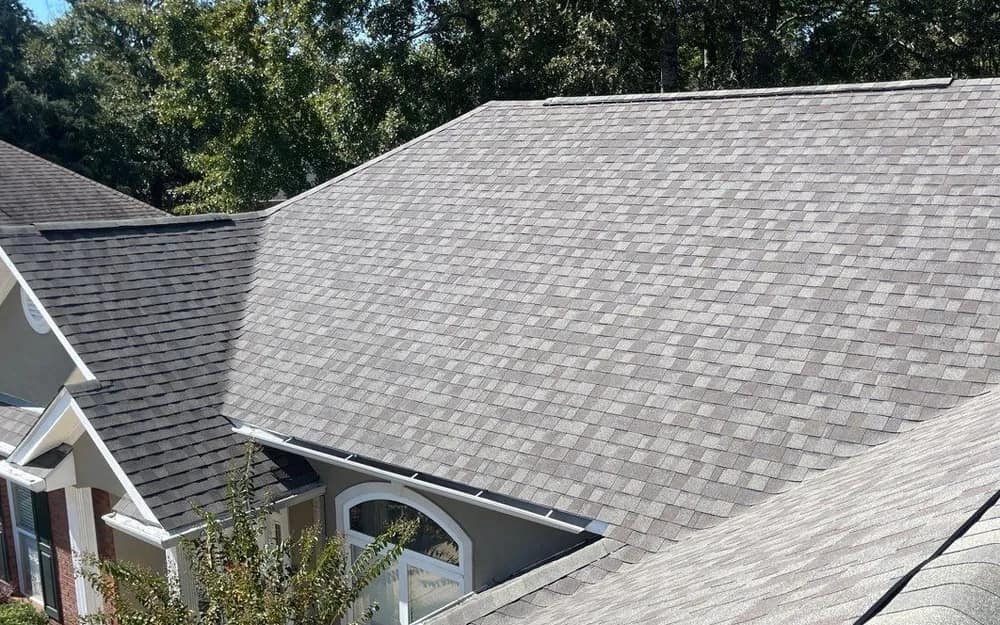 Sunlit finished architectural shingle roof on a brick Baldwin County home, seen from above